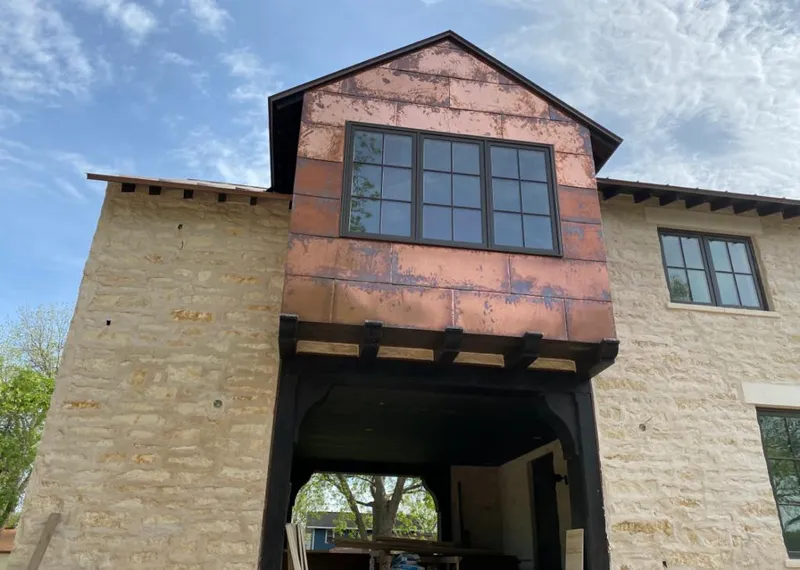 Copper metal panel facade on a stone building for Roof Repair in Wyoming